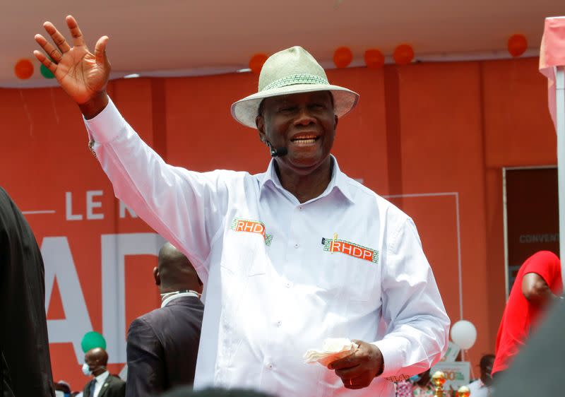 Ivory Coast President Alassane Ouattara waves as he arrives for the meeting of the ruling coalition party RHDP organised to nominate him to stand for a third term in October's election in Abidjan