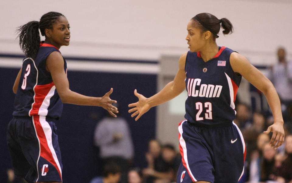 FILE - In this Jan. 31, 2009, file photo, Connecticut's Maya Moore (23) is congratulated by Tiffany Hayes after scoring against Georgetown during the second half of an NCAA college basketball game in Washington. Renee Montgomery and Hayes appreciated what former UConn teammate Moore was doing when the All-Star forward stepped away from basketball two years ago to focus on criminal justice reform. The Atlanta Dream guards admit they weren't sure why she couldn't continue keep playing at the same time. Now they have a better understanding. (AP Photo/Luis M. Alvarez, File)