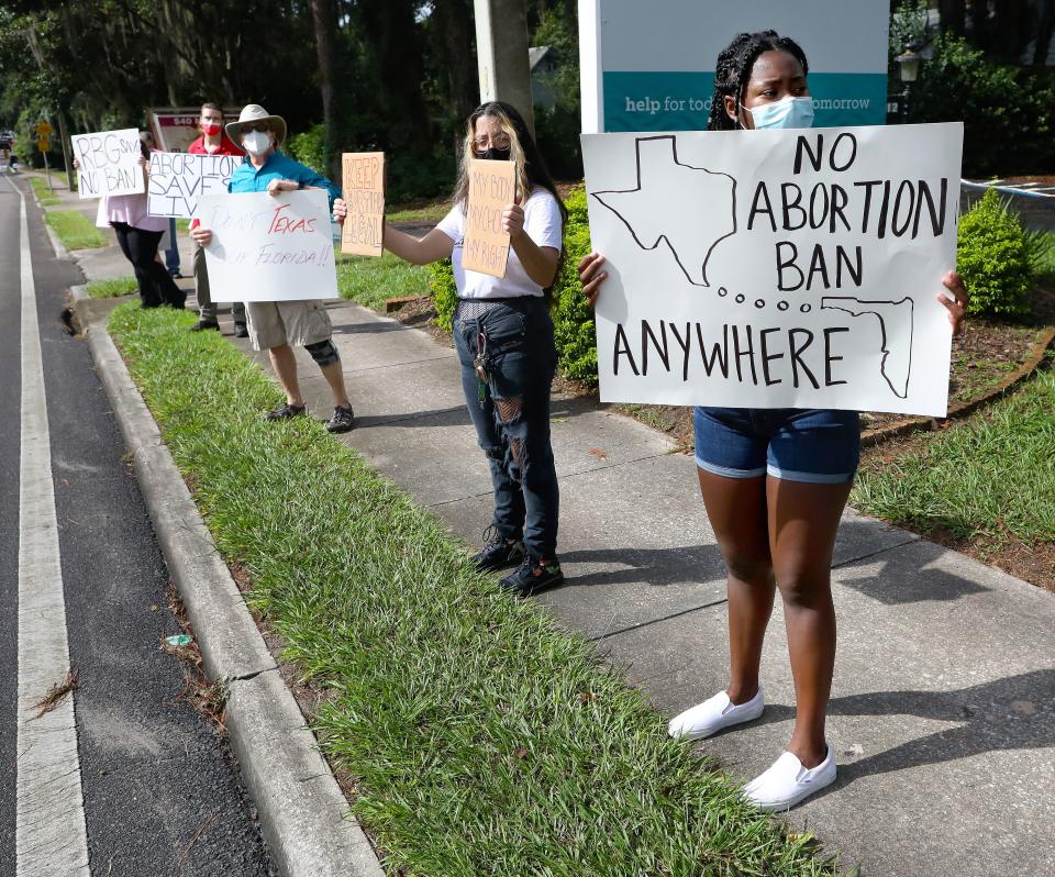 Lys Valcin, right, and Jianna D'Addario, both with Planned Parenthood Generation Action, demonstrate with others against a possible ban on abortions in Florida, near the Planned Parenthood clinic off NW 13th Street in Gainesville, Fla. Sept. 9, 2021. The Florida legislation is considering creating a ban on abortions similar to the one that recently went in effect in Texas.