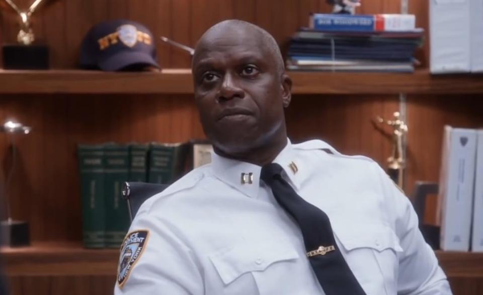 Holt sitting at his desk in "Brooklyn Nine-Nine"