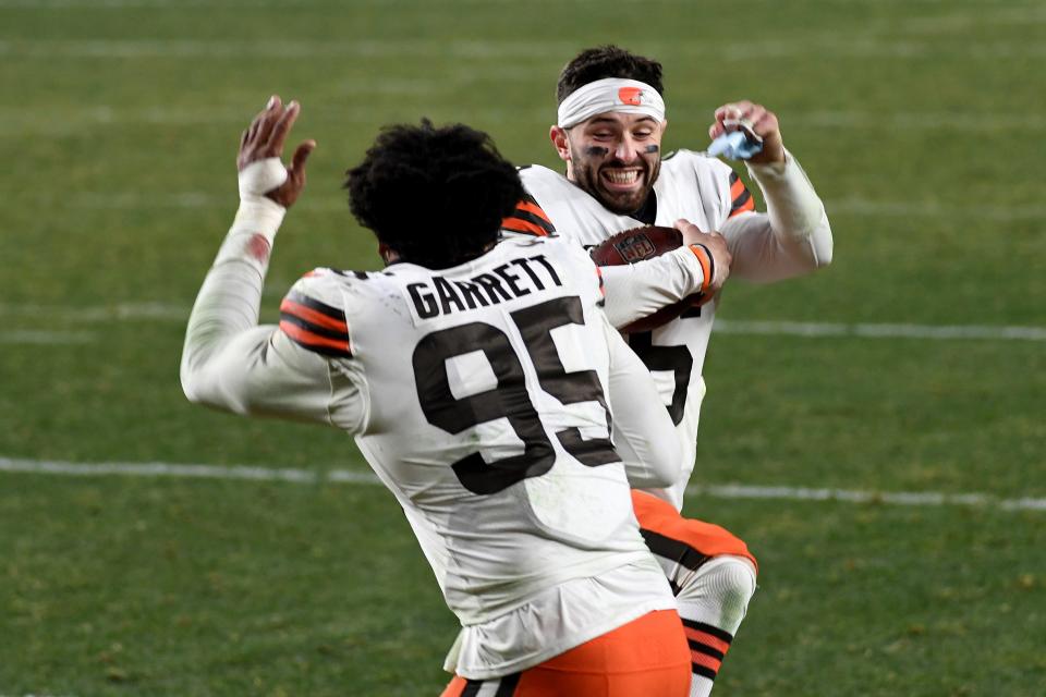FILE - Cleveland Browns quarterback Baker Mayfield (6) celebrates with defensive end Myles Garrett (95) after defeating the Pittsburgh Steelers 48-37 during an NFL wild-card playoff football game, Sunday, Jan. 10, 2021, in Pittsburgh. The hype surrounding the Browns' upcoming reunion with Mayfield has already begun and figures to build. Garrett plans to treat it like any other game.(AP Photo/Justin Berl, File)