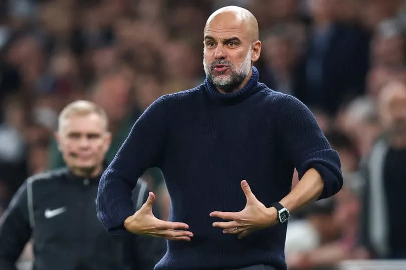 Pep Guardiola gestures on the sidelines during Manchester City's win over Tottenham