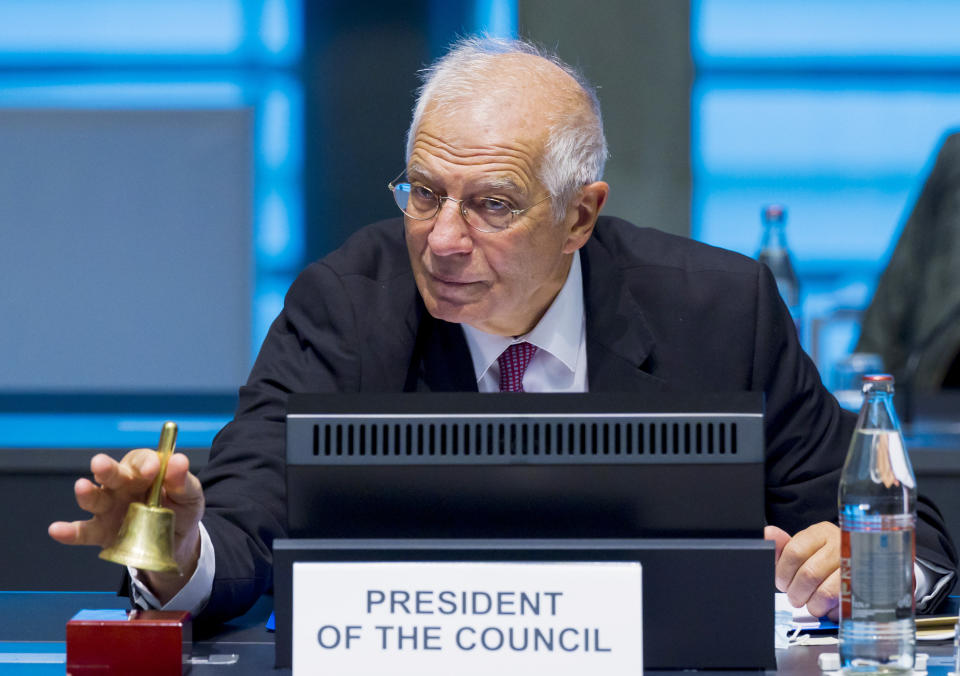 European Union foreign policy chief Josep Borrell rings a bell to signal the start of a meeting of European Union foreign ministers at the European Council building in Luxembourg, Monday, Oct. 12, 2020. European Union foreign ministers were weighing Monday whether to impose sanctions on Russian officials and organizations blamed for the poisoning of opposition leader Alexei Navalny with a Soviet-era nerve agent. (Jean-Christophe Verhaegen, Pool via AP)