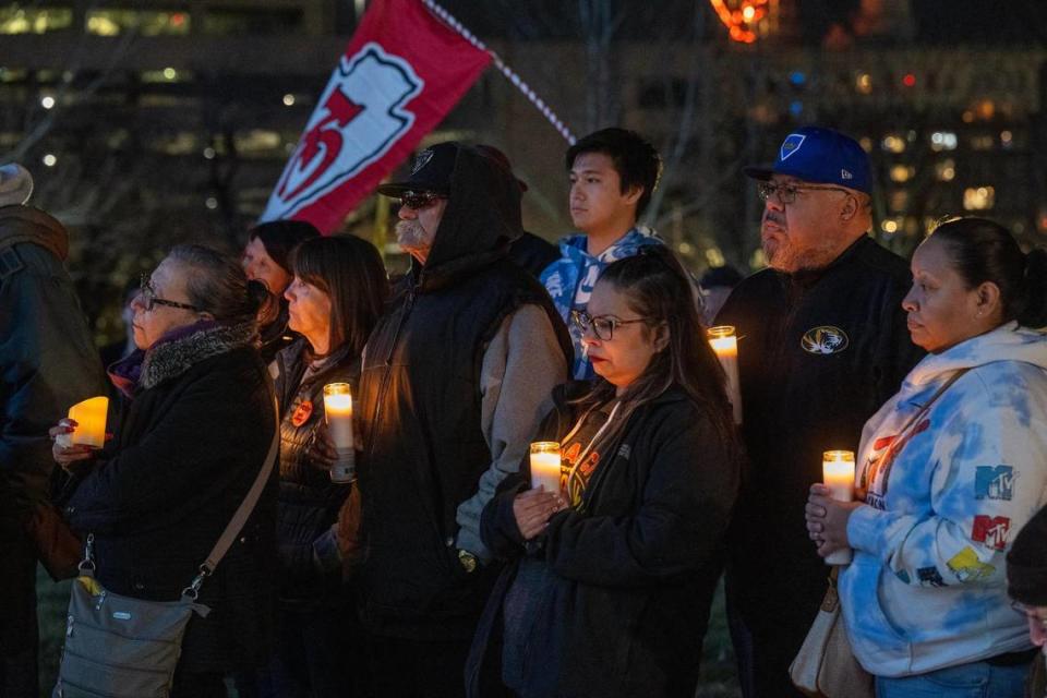 Members of the community, including Christina and Daniel Nunez, second from right, gathered at Skywalk Memorial Park in Kansas City for a candlelight vigil Thursday night to show support for the victims of the mass shooting, including their longtime friend, Lisa Lopez-Galvan, who was killed in the shooting on Wednesday during the Chiefs Super Bowl rally.