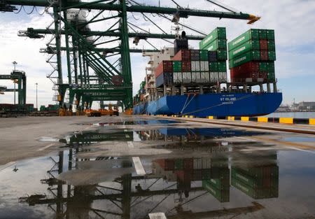 FILE PHOTO: A ship is unloaded at New Priok Container Terminal One in Tanjung Priok, north Jakarta, Indonesia November 16, 2016. REUTERS/Darren Whiteside/File Photo