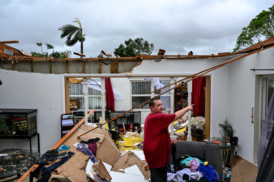 Robert Haight looks around his destroyed house after it was hit by a reported tornado in Fort Myers (AFP via Getty Images)