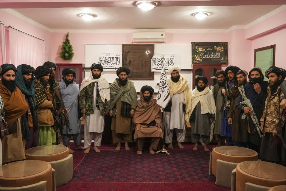 Badghis Deputy Governor Molwi Mohibullah Asad (in the middle) and other members of Taliban line up for the interview in the governors office in Qala-e-Naw Afghanistan, Saturday, Dec. 13, 2021. Severe drought has dramatically worsened the already desperate situation in Afghanistan forcing thousands of people to flee their homes and live in extreme poverty. Experts predict climate change is making such events even more severe and frequent. (AP Photo/Mstyslav Chernov)