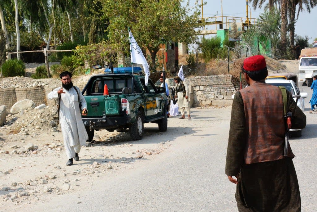 File: Taliban members inspect the site of a blast carried out by the Isis-K in Jalalabad on 18 September (AFP via Getty Images)