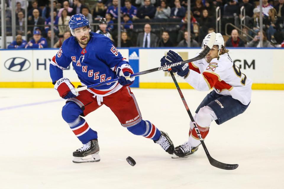 Mar 4, 2024; New York, New York, USA; New York Rangers defenseman Erik Gustafsson (56) and Florida Panthers left wing Ryan Lomberg (94) chases the puck in the first period at Madison Square Garden.