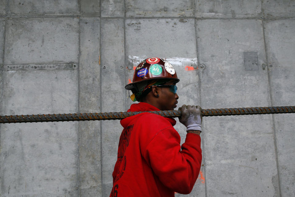 A worker carries a piece of rebar at the World Trade Center transportation hub in New York May 6, 2013.  REUTERS/Eric Thayer  