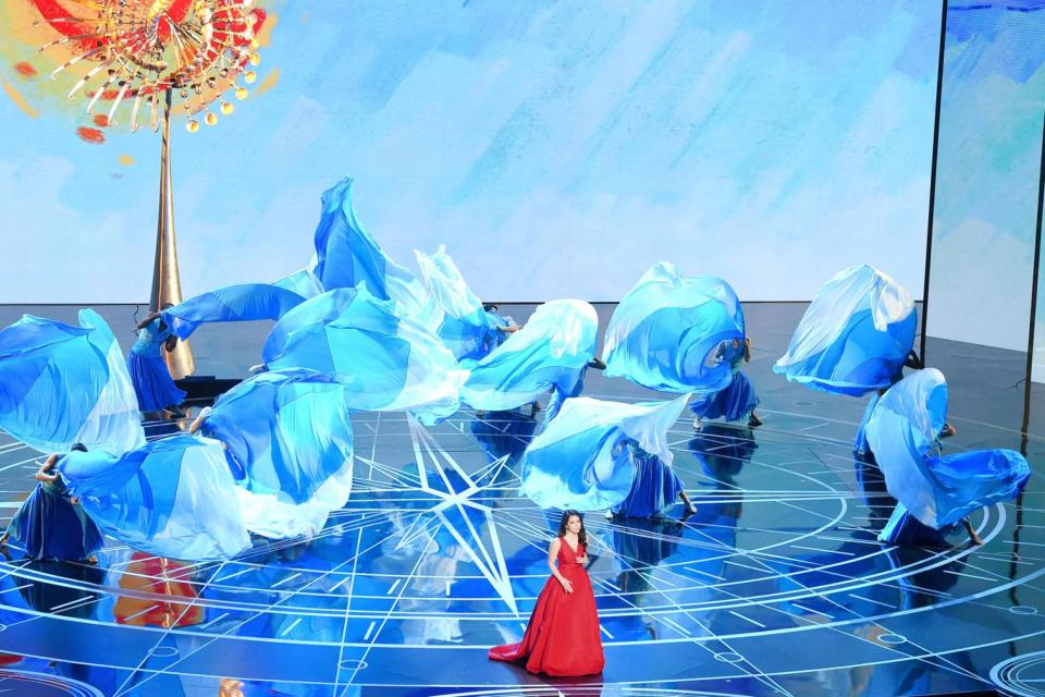 Flag It: Auli'i Cravalho with the backing dancers twirling their blue flags (Kevin Winter/Getty Images)