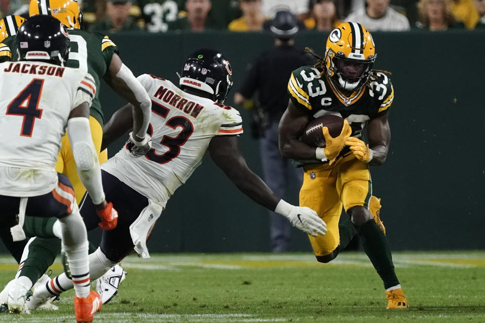 Green Bay Packers running back Aaron Jones (33) runs from Chicago Bears linebacker Nicholas Morrow (53) during the second half of an NFL football game Sunday, Sept. 18, 2022, in Green Bay, Wis. (AP Photo/Morry Gash)