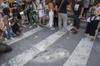 <p>People take photographs and record video footage of white markings on the ground outside the U.S. Embassy following an explosion in Beijing, Thursday, July 26, 2018. (Photo: Gilles Sabrie/Bloomberg via Getty Images) </p>