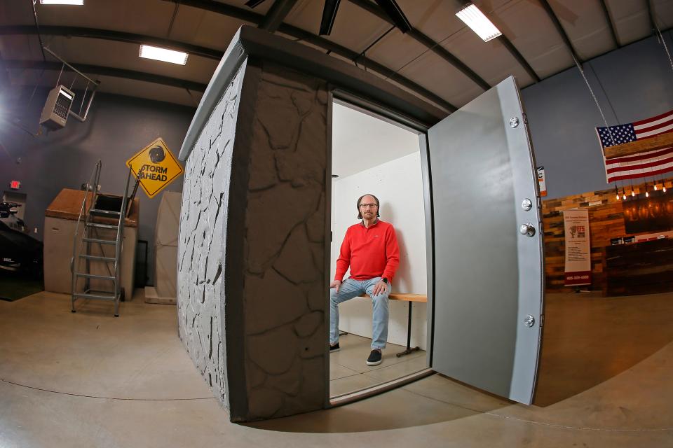 Brian Koons with EF5 Tornado Shelters, 14300 N Lincoln Blvd., No. 100, sits inside an above-ground storm shelter on display in the showroom.