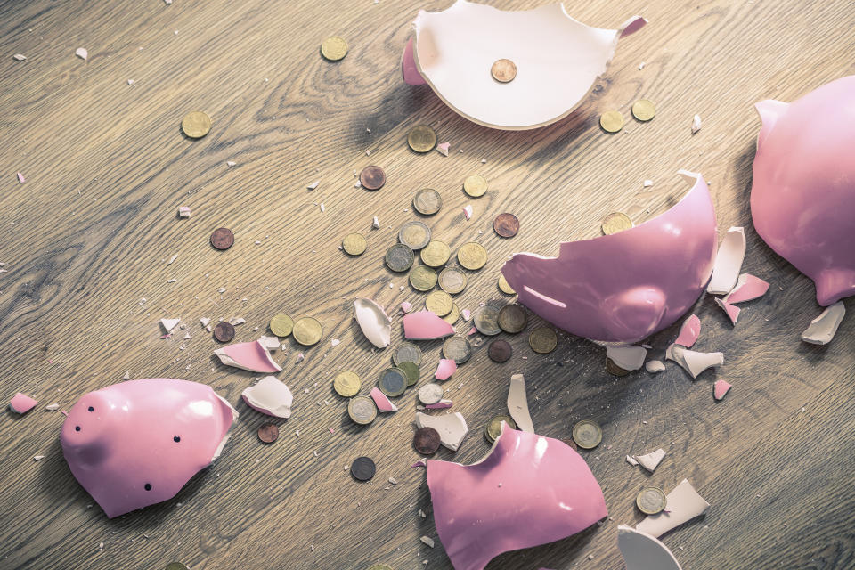 Broken piggy bank and coins
