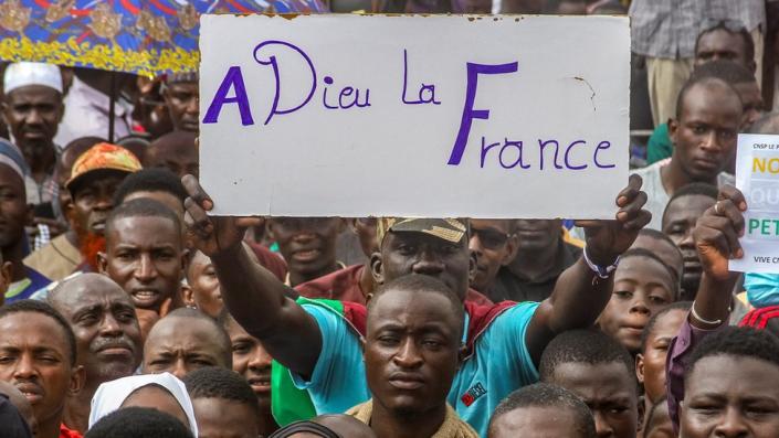 A man holds up a placard during a march in Niamey
