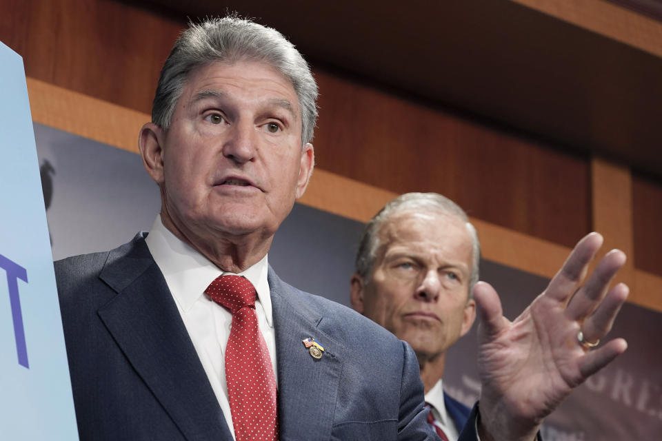 Sen. Joe Manchin, D-W. Va., left, and Sen. John Thune. R-S.D., right, speak during the news conference to introduce the Restricting the Emergence of Security Threats that Risk Information Communications Technology Act, or RESTRICT Act, Tuesday, March 7, 2023, on Capitol Hill in Washington. (AP Photo/Mariam Zuhaib)