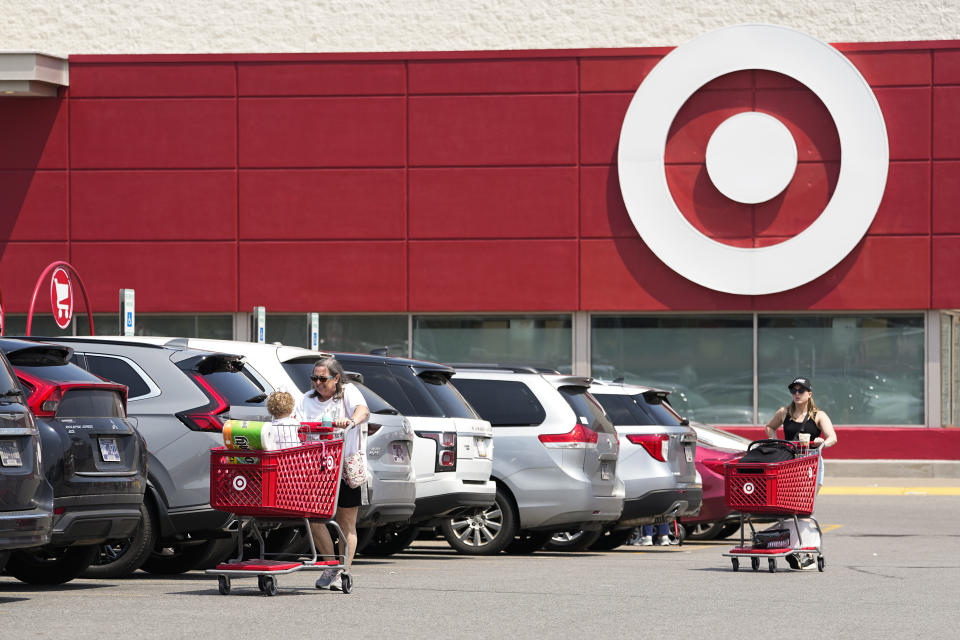 FILE - Customers make their way through the parking lot of a Target store Wednesday, May 24, 2023, in Nashville, Tenn. On Friday, June 2, The Associated Press reported on stories circulating online incorrectly claiming photos of a goat-headed store mannequin and a girl wearing a black shirt with a pentagram design show Target is selling a line of satanic-themed children’s clothing. (AP Photo/George Walker IV, File)