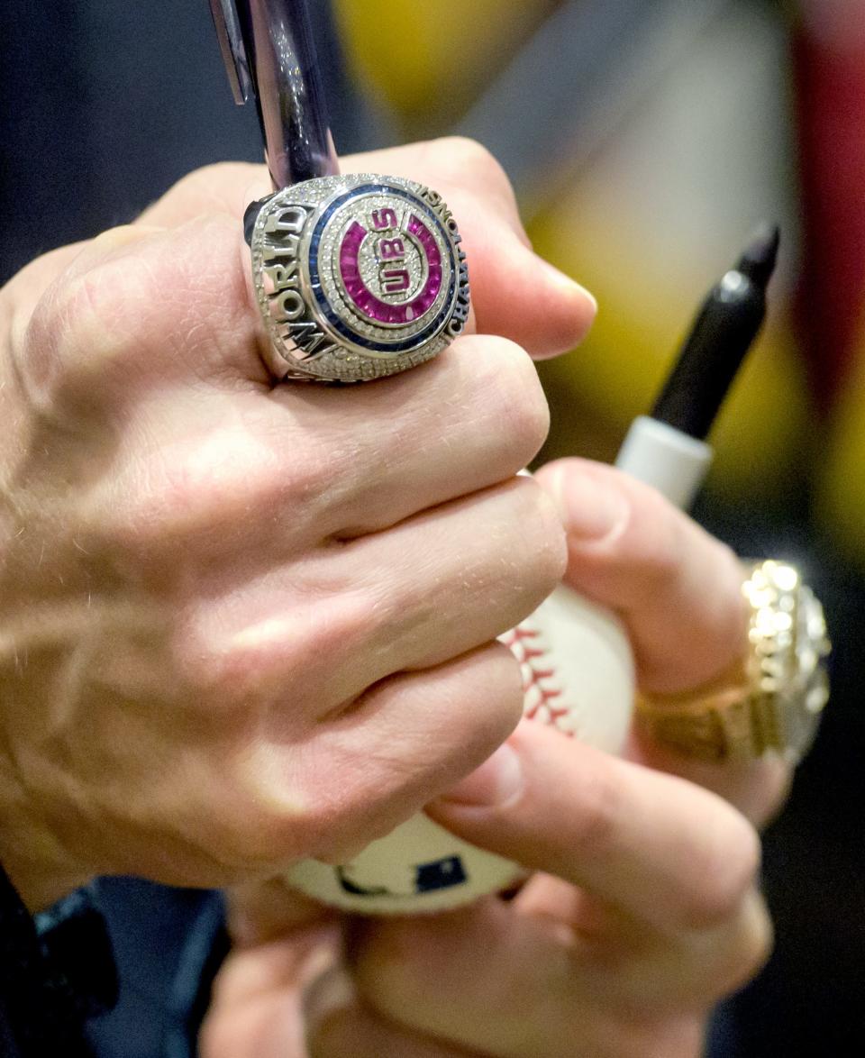 Former Chicago Cubs and Kansas City Royals star Ben Zobrist sports his World Series rings as he signs a baseball for a fan after the induction ceremony for the 2023 Greater Peoria Sports Hall of Fame on Saturday, March 25, 2023 at the Peoria Civic Center.