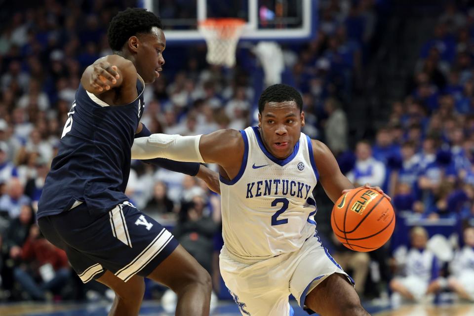 Kentucky's Sahvir Wheeler (2) drives on Yale's Bez Mbeng, left, during the first half of an NCAA college basketball game in Lexington, Ky., Saturday, Dec. 10, 2022. (AP Photo/James Crisp)