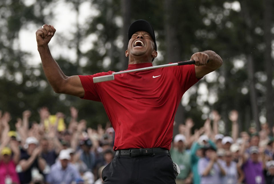 FILE - In this April 14, 2019 file photo, Tiger Woods reacts as he wins the Masters golf tournament in Augusta, Ga. Woods' victory at the Masters might not have been the most important sports story of 2019. It was certainly one of the most uplifting. Voters chose Woods' dramatic comeback at Augusta National as The Associated Press sports story of the year. (AP Photo/David J. Phillip, File)