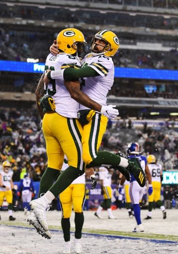 Green Bay quarterback Aaron Rodgers and teammate Marcedes Lewis celebrate a touchdown in the Packers' 31-13 NFL victory over the New York Giants