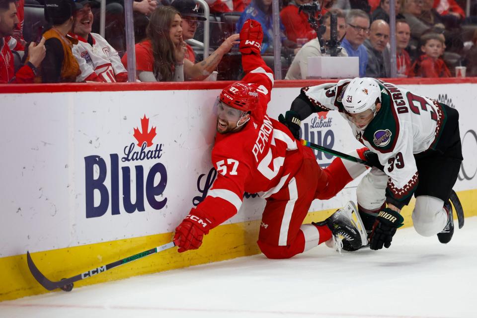 Red Wings left wing David Perron and Coyotes defenseman Travis Dermott battle for the puck in the second period Mar 14, 2024; Detroit, Michigan, USA; Detroit