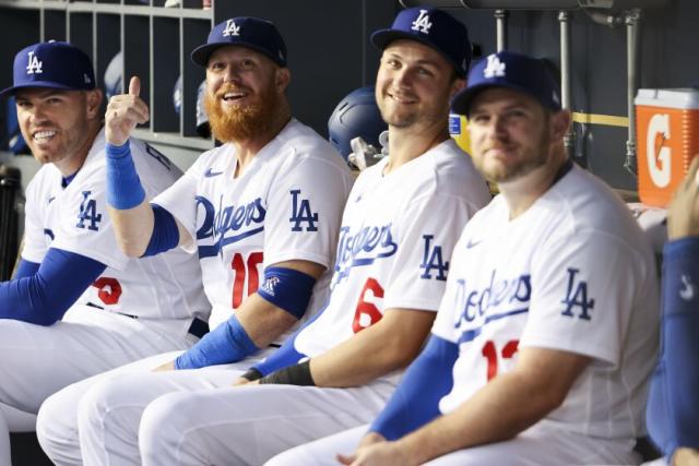 Los Angeles Dodgers' Justin Turner, right, smiles at Freddie Freeman after  he hit a sacrifice f …