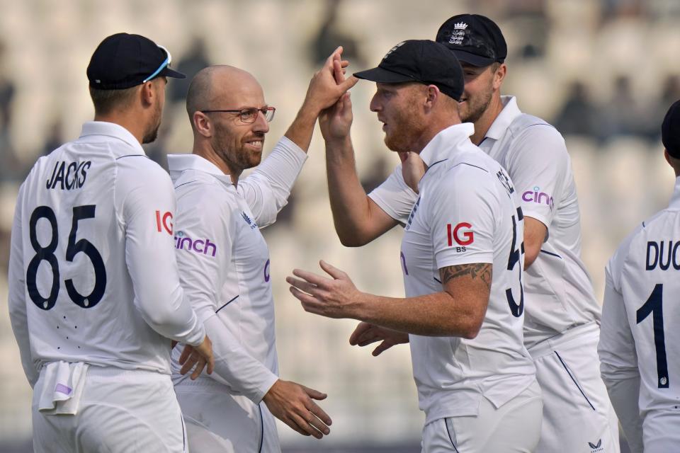 England's Jack Leach, second left, celebrates with teammates after taking wicket of Pakistan Saud Shakeel during the second day of the second test cricket match between Pakistan and England, in Multan, Pakistan, Saturday, Dec. 10, 2022. (AP Photo/Anjum Naveed)