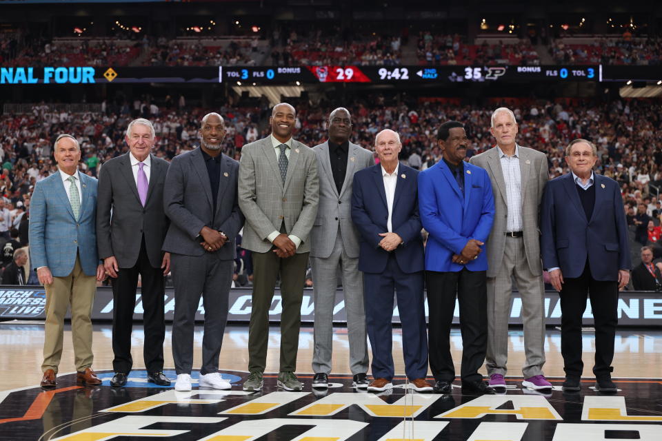 GLENDALE, ARIZONA - APRIL 06: (L-R) John Doleva, Jerry Colangelo, Chauncey Billups, Vince Carter, Michael Cooper, Bo Ryan, Charles Smith, Doug Collins and Herb Simon pose for photos during a ceremony honoring the Naismith Basketball Hall Of Fame Class Of 2024 at halftime of the NCAA Men's Basketball Tournament Final Four semifinal game between the North Carolina State Wolfpack and the Purdue Boilermakers at State Farm Stadium on April 06, 2024 in Glendale, Arizona. (Photo by Christian Petersen/Getty Images)