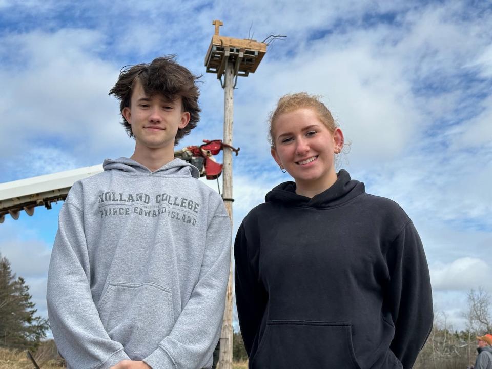 Charlottetown Rural high school students Tihan Stapleton (left) and Lydia Doyle stand in front of the new osprey platform at their school. 