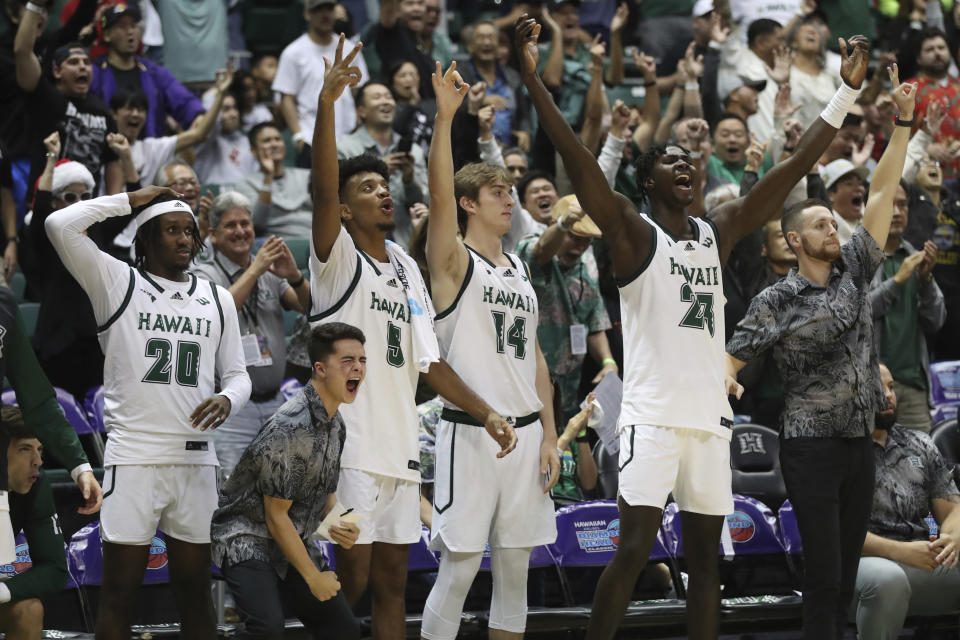 The Hawaii bench reacts to play against Washington State during the second half of an NCAA college basketball game, Friday, Dec. 23, 2022, in Honolulu. Hawaii defeated Washington State 62-51. (AP Photo/Marco Garcia)