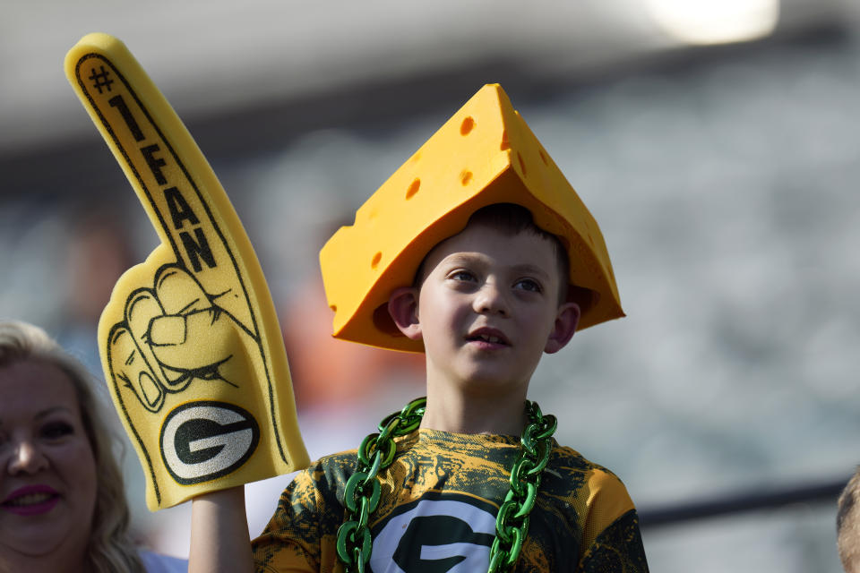 A Green Bay Packers fan watches warmups before the Packers' preseason NFL football game against the Cincinnati Bengals on Friday, Aug. 11, 2023, in Cincinnati. (AP Photo/Michael Conroy)