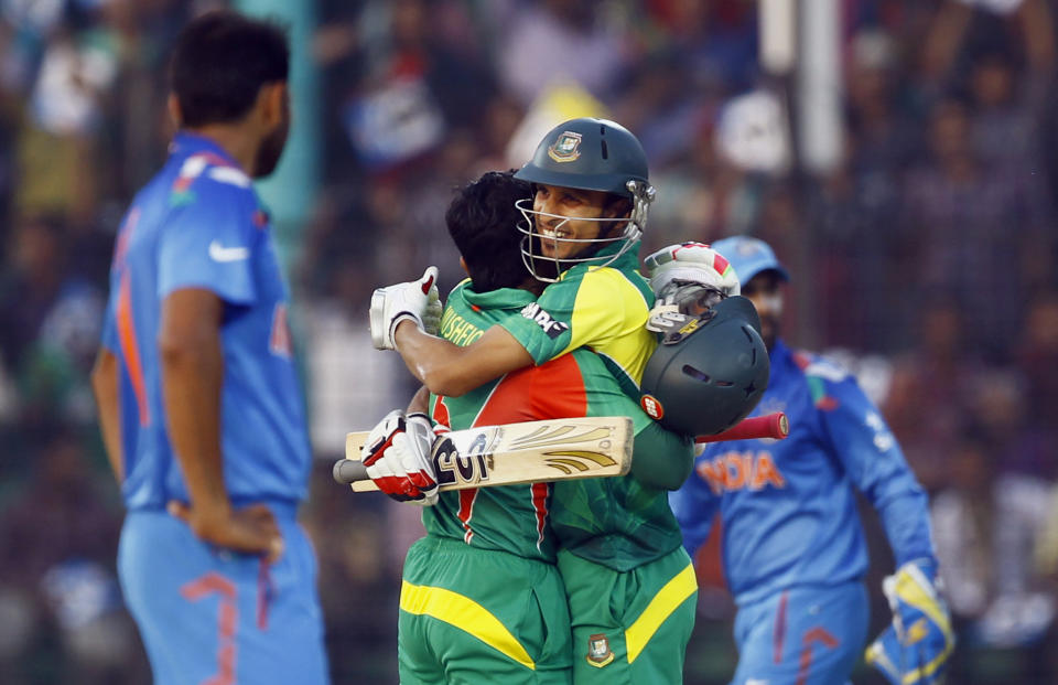 Bangladesh's Mushfiqur Rahim, center left, embraces teammate Nasir Hossain after scoring a century during the Asia Cup one-day international cricket tournament against India in Fatullah, near Dhaka, Bangladesh, Wednesday, Feb. 26, 2014. (AP Photo/A.M. Ahad)