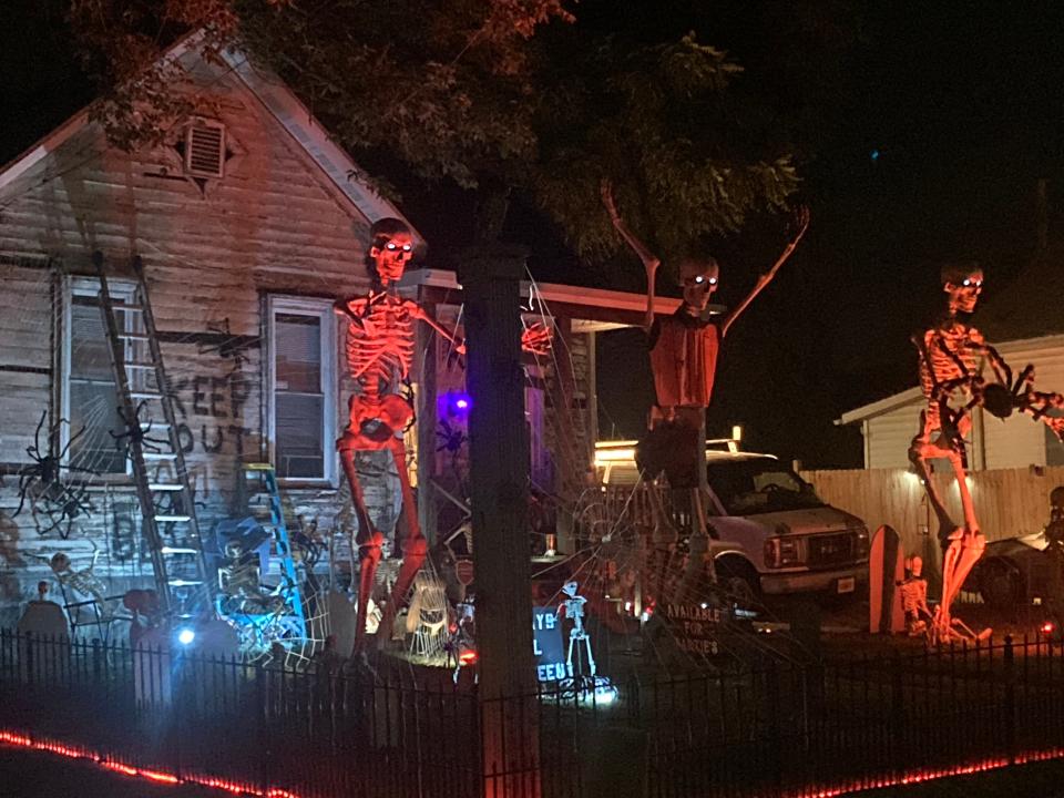 A nighttime version of Ed Stark's decorated house in the 700 block of Eastman Avenue in Springfield. It includes several 12-foot tall skeletons, one of which Stark said can be rented out.
