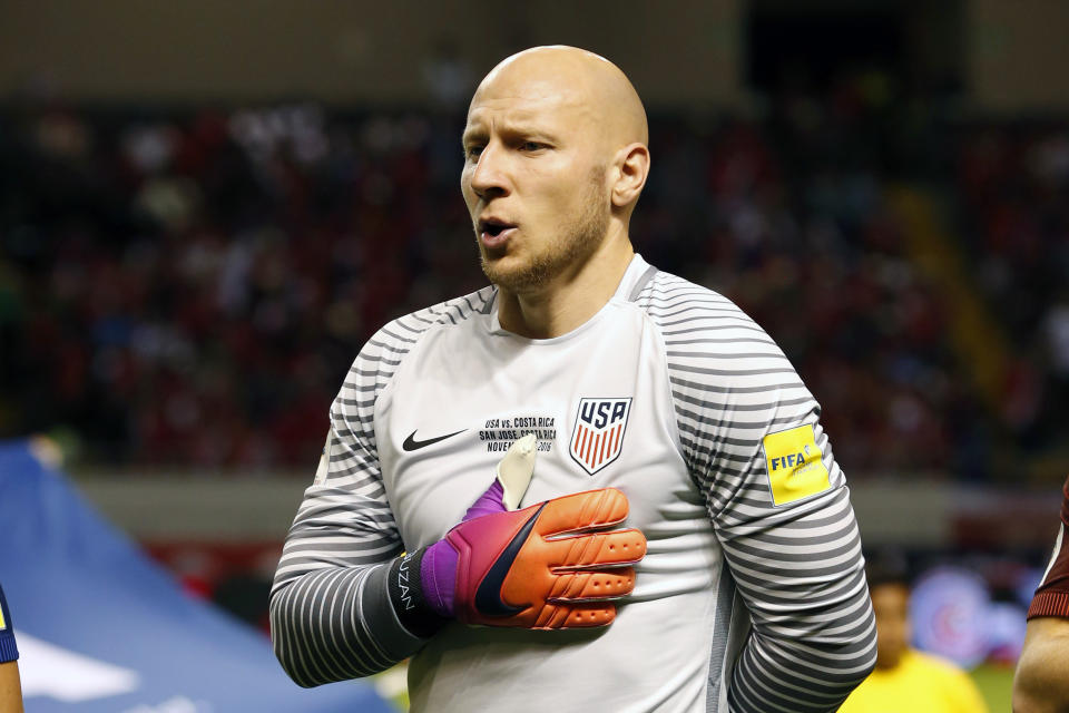 FILE - In this Nov. 15, 2016, file photo, United States goalkeeper Brad Guzan sings the national anthem before a 2018 World Cup qualifying soccer match against Costa Rica, in San Jose, Costa Rica. Guzan and midfielder Michael Bradley are back with the U.S. national team, two days shy of the first anniversary of the most crushing defeat in the team’s history. (AP Photo/Moises Castillo, File)