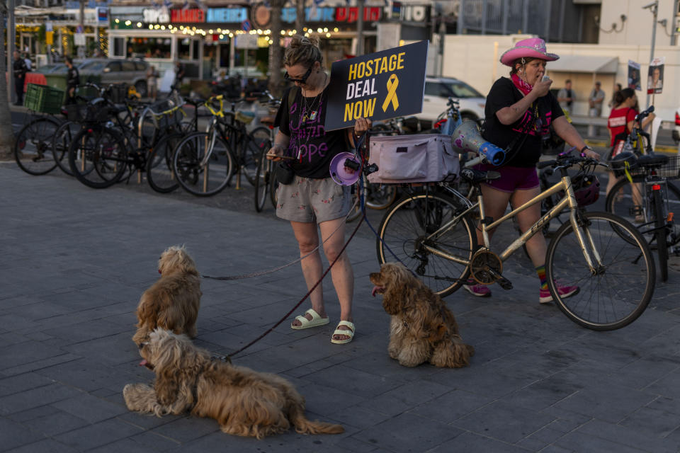 A Demonstrator holds sign during a protest calling for the release of the hostages from Hamas captivity in the Gaza Strip, outside of the U.S. Embassy Branch Office in Tel Aviv, Israel, Monday, June 3, 2024. (AP Photo/Ariel Schalit)