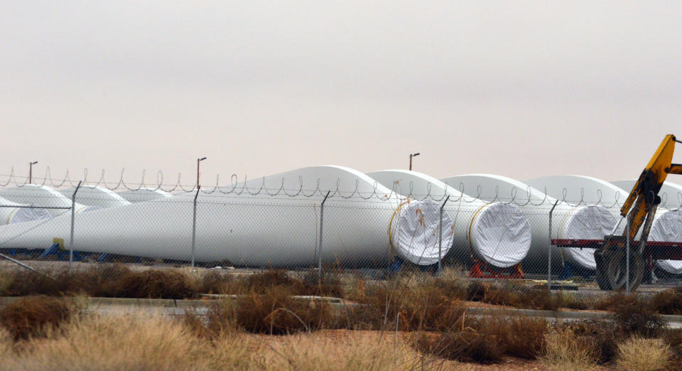 FILE - In this Jan. 5, 2016 photo, blades for wind turbines sit in a field in the booming New Mexico town of Santa Teresa along the U.S.-Mexico border. The federal government has finished another environmental review of a proposed transmission line that will carry wind-generated electricity from rural New Mexico to big cities in the West and similar reviews are planned for two more projects that would span parts of Utah and Nevada, the U.S. Interior Department announced Thursday, April 28, 2022. (AP Photo/Russell Contreras, File)