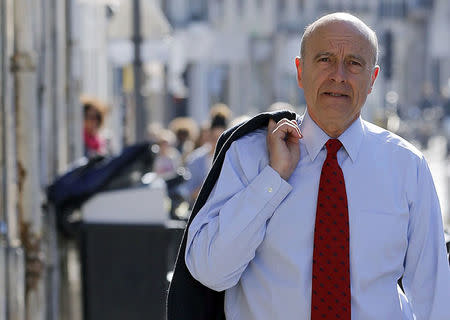 Alain Juppe, former French prime minister and current Mayor of Bordeaux, walks in the street as he campaigns for the municipal elections in Bordeaux, southwestern France, March 20, 2014. REUTERS/Regis Duvignau