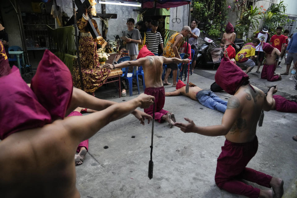 Hooded Filipino flagellants pray as part of Maundy Thursday rituals to atone for sins or fulfill vows for an answered prayer on April 6, 2023 at Mandaluyong city, Philippines. COVID restrictions the past years have prevented crowds and devotees in participating in lenten rituals, a practice which have been opposed by the church in this predominantly Roman Catholic country. (AP Photo/Aaron Favila)