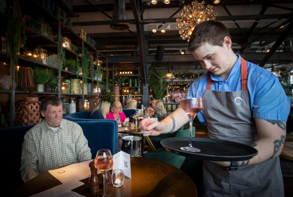 Barman Matthew Williams serves drinks at Scotts in South Queensferry. Hospitality vacancies have hit record levels as bosses have warned staff shortages are impact trade (Jane Barlow/PA) (PA Archive)