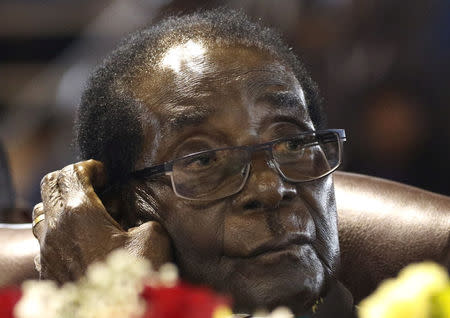 FILE PHOTO: Former President of Zimbawe Robert Mugabe listens before addressing a meeting of veterans of the country's independence war in the capital Harare, April 7, 2016. REUTERS/Philimon Bulawayo/File Photo