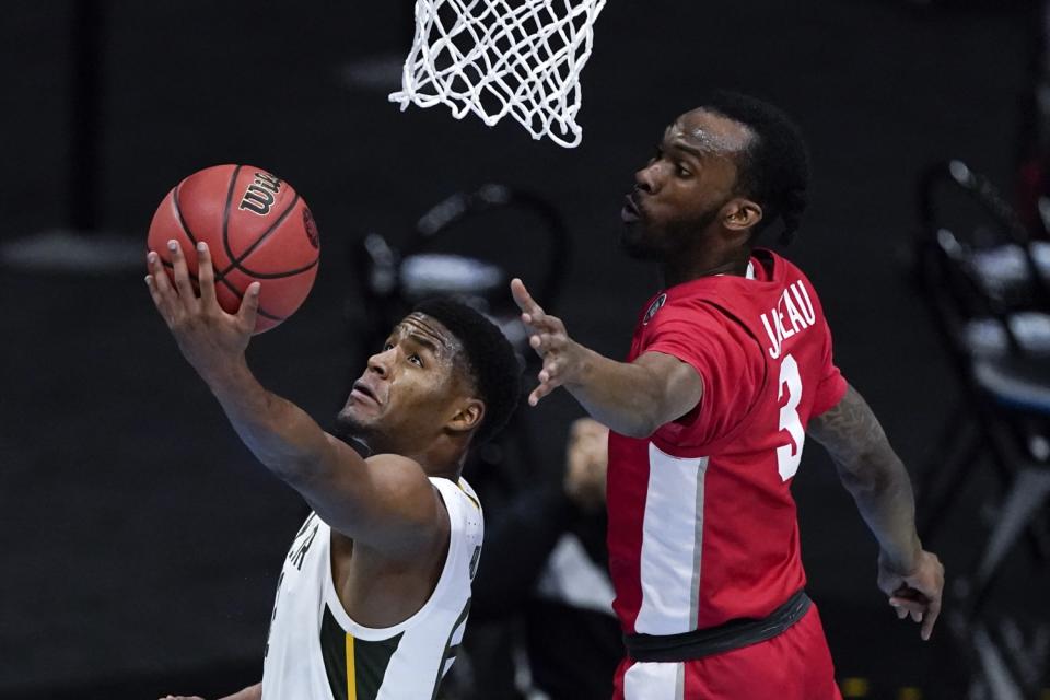 Baylor guard Jared Butler attempts a reverse layup against Houston guard DeJon Jarreau.