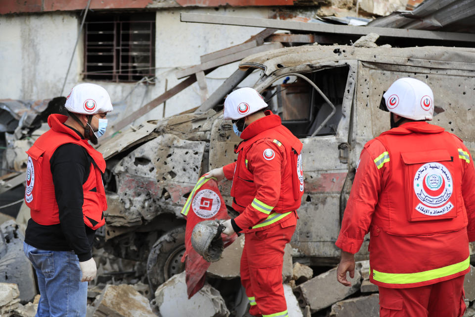 Paramedics collect equipment of their comrades killed at a paramedic center after it was hit by an Israeli airstrike early Wednesday in Hebbariye village, south Lebanon, Wednesday, March 27, 2024. The Israeli airstrike on a paramedic center linked to a Lebanese Sunni Muslim group killed several people of its members. The strike was one of the deadliest single attacks since violence erupted along the Lebanon-Israel border more than five months ago. (AP Photo/Mohammed Zaatari)