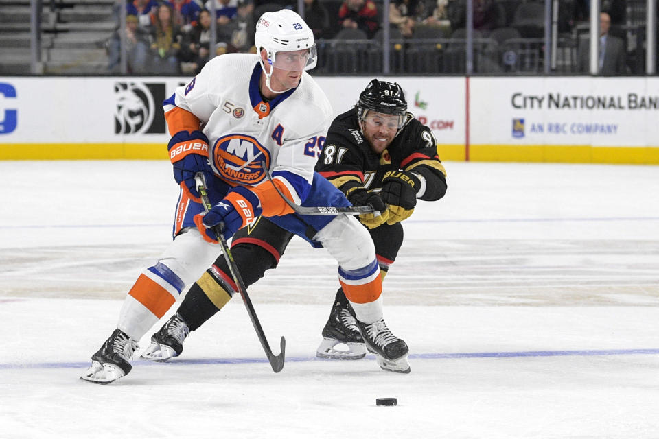 Vegas Golden Knights center Jonathan Marchessault (81) defends New York Islanders center Brock Nelson (29) during the third period of an NHL hockey game Saturday, Dec. 17, 2022, in Las Vegas. The Islanders defeated the Golden Knights 5-2. (AP Photo/Sam Morris)