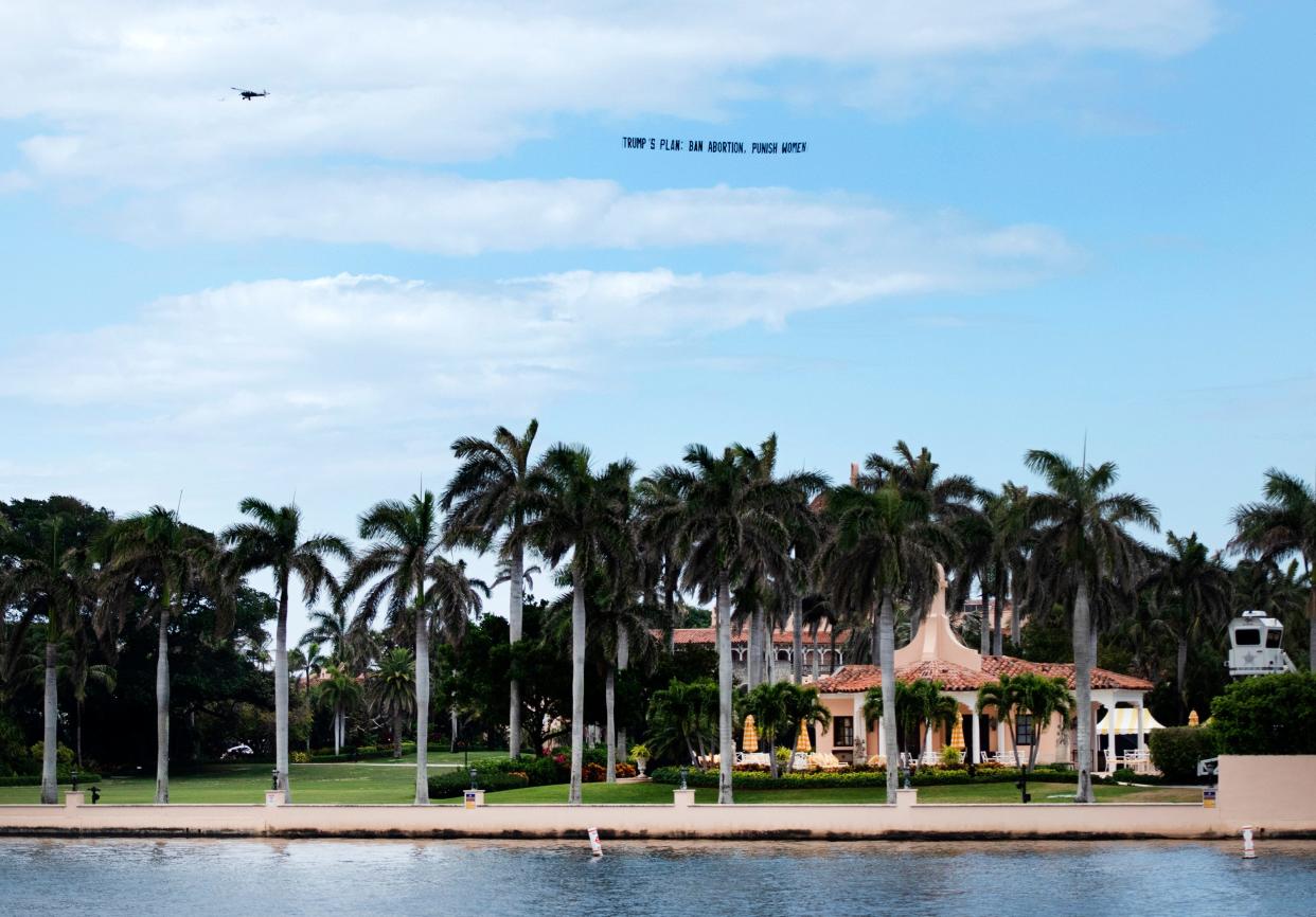 The Democratic National Committee flew a banner that read "Trump's Plan: Ban Abortion, Punish Women," near Mar-a-Lago Club Wednesday in Palm Beach.