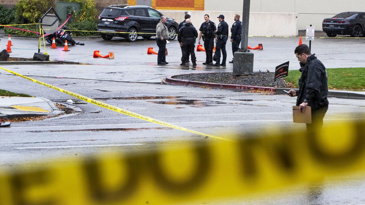 Police collect evidence in a parking lot near Dave and Busters near the Boise Towne Square shopping mall where a shooting occurred Monday, Oct. 25, 2021, in Boise, Idaho. 