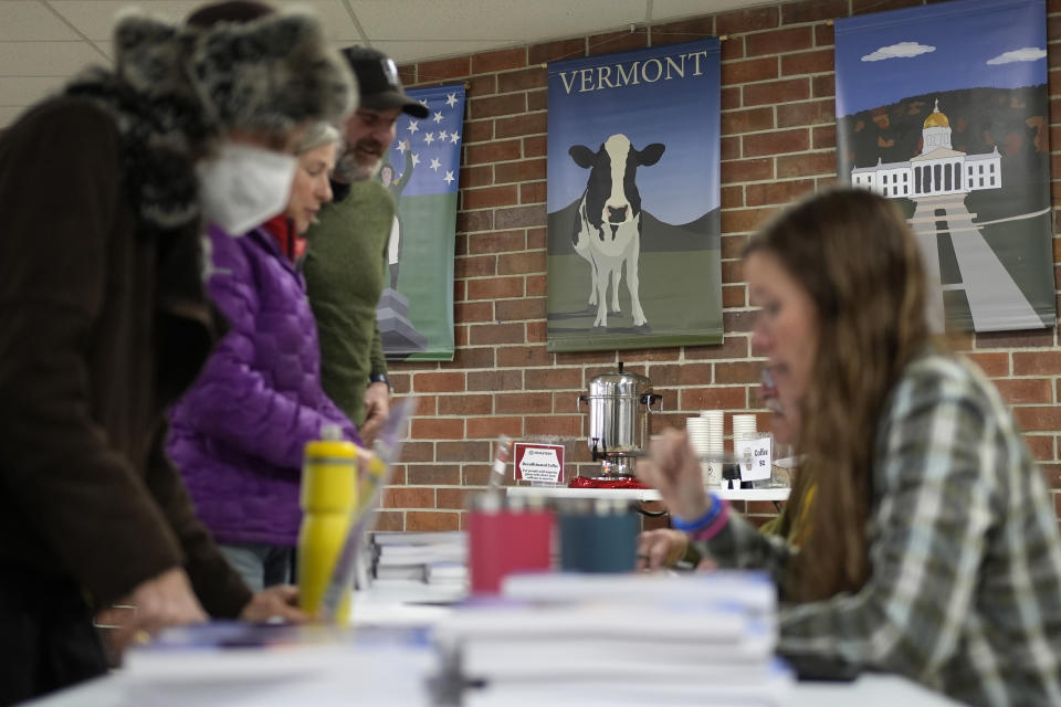 Residents sign in before attending the annual Town Meeting at the high school, Tuesday, March 5, 2024, in Stowe, Vt. Town Meeting is a New England tradition that dates back more than 250 years. It offers people a chance to get directly involved in local democracy. One day each year, townsfolk gather to hash out local issues, such as whether to buy a new firetruck or donate some money to the local food pantry. (AP Photo/Robert F. Bukaty)