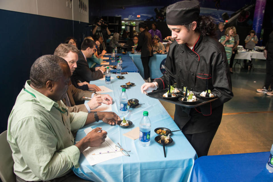 Students serve their dishes to judges during the HUNCH Culinary Challenge Finals at Space Center Houston on April 21, 2016. Astronauts, NASA food scientist, and International Space Station program officials were among the