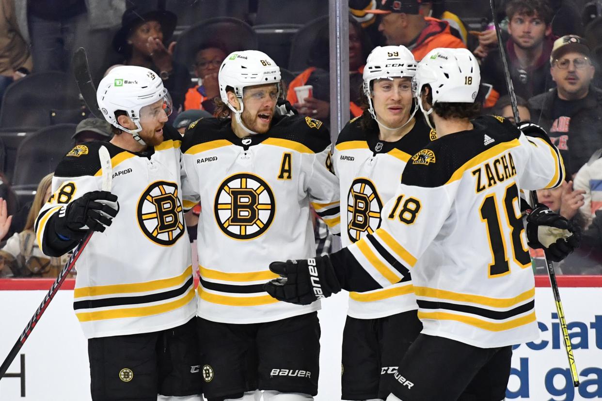 Boston Bruins right wing David Pastrnak (88) celebrates a goal with teammates.